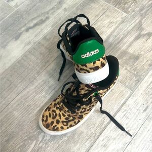 Leopard print adidas shoes with green leather details and pink writing.